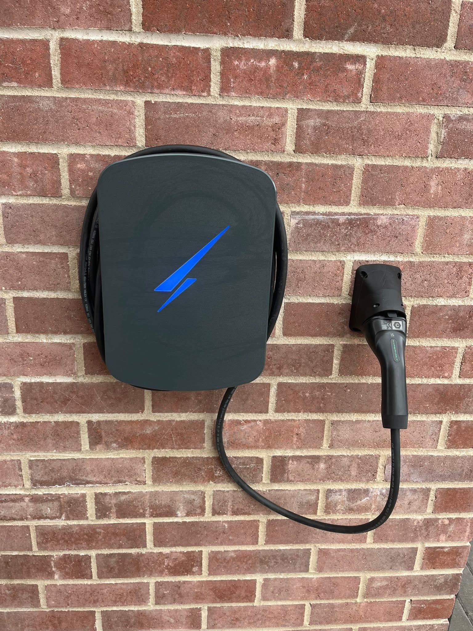 EV charger installed on a brick wall